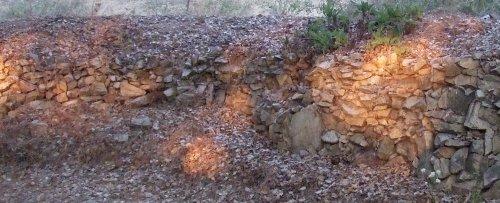 Rocks stacked against a dirt face.