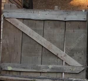 A wooden gate showing the cross brace.