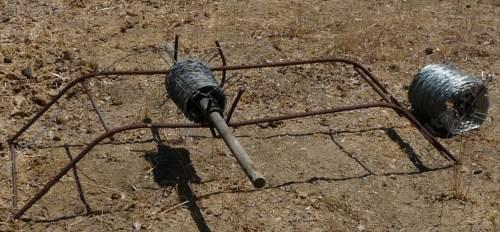 You can make a version of this out of wood, or you can use the water wand and put a post into the ground 2-3 feet and hold the roll with that.