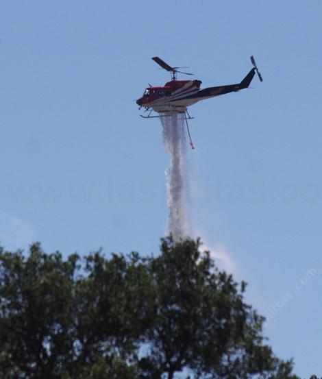 A helicopter dropping water across the street from the nursery. - grid24_12