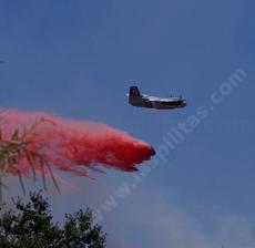 A bomber dropping fire retardant across the street from the nursery. - grid24_6