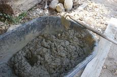 Mixing cement in the wheelbarrow is ok for small jobs like a bench base. 1 part portland cement, 3 parts or so coarse sand. - grid24_6