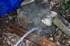 After a few minutes lightly wash the excess mortar off of the rocks so the bench base looks like rock, not cement. - grid24_6