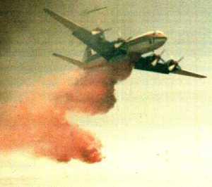 A tanker dropping fire regardant on a wildland fire.