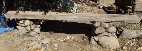 The finished rock pillar, with two old 2X6's on top. Total cost of bench, $4 of cement, some sand, two old 2X6's and two short pieces of treated 4X4. Simple, fairly easy and cheap. - grid24_12 The finished rock pillar, with two old 2X6's on top. Total cost of bench, $4 of cement, some sand, two old 2X6's and two short pieces of treated 4X4. Simple, fairly easy and cheap. - grid24_12