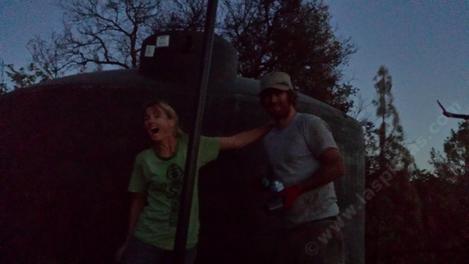 Penny and Ian next to the new water tank installed on the remains of the melted water tank (in 2016 fire). - grid24_12