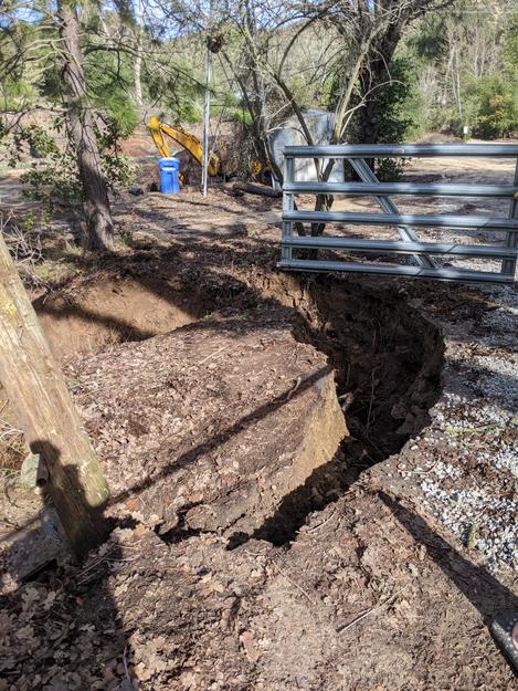 Driveway starting to break off after 2023 flooding pushed water over the top. - grid24_12