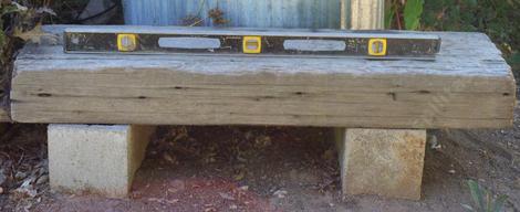 A slab of wood on blocks makes a garden bench. - grid24_12 A slab of wood on blocks makes a garden bench. - grid24_12